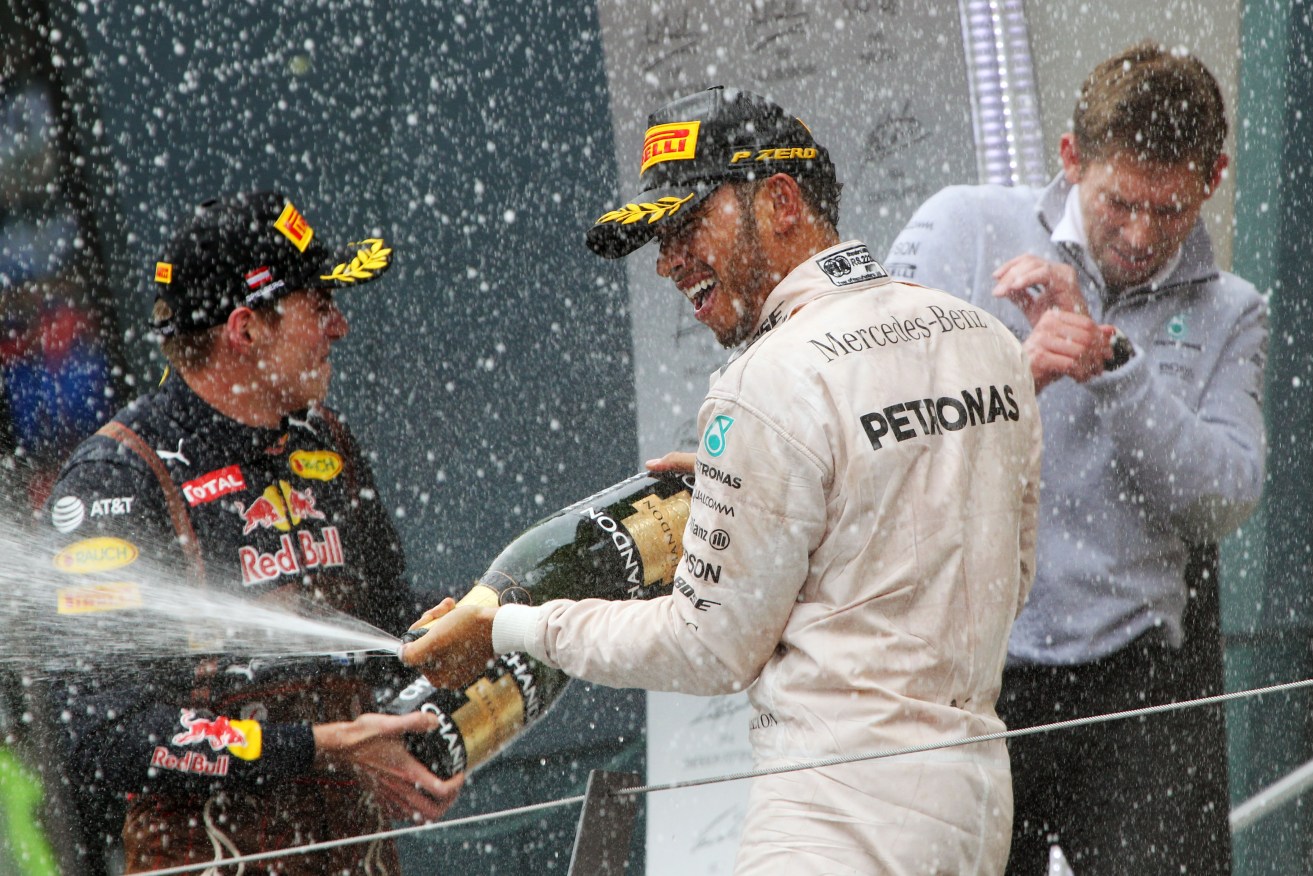 Race winner Lewis Hamilton celebrates on the podium. Photo:  XPB/Press Association Images.