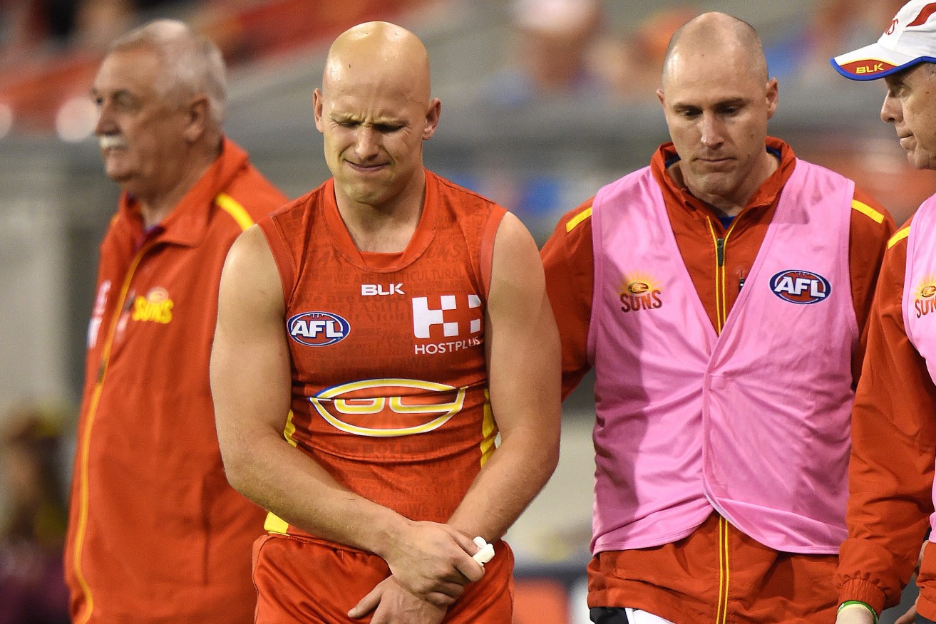 Gary Ablett is taken from the field after injuring his shoulder in the final term on Saturday. Photo: Dave Hunt, AAP.