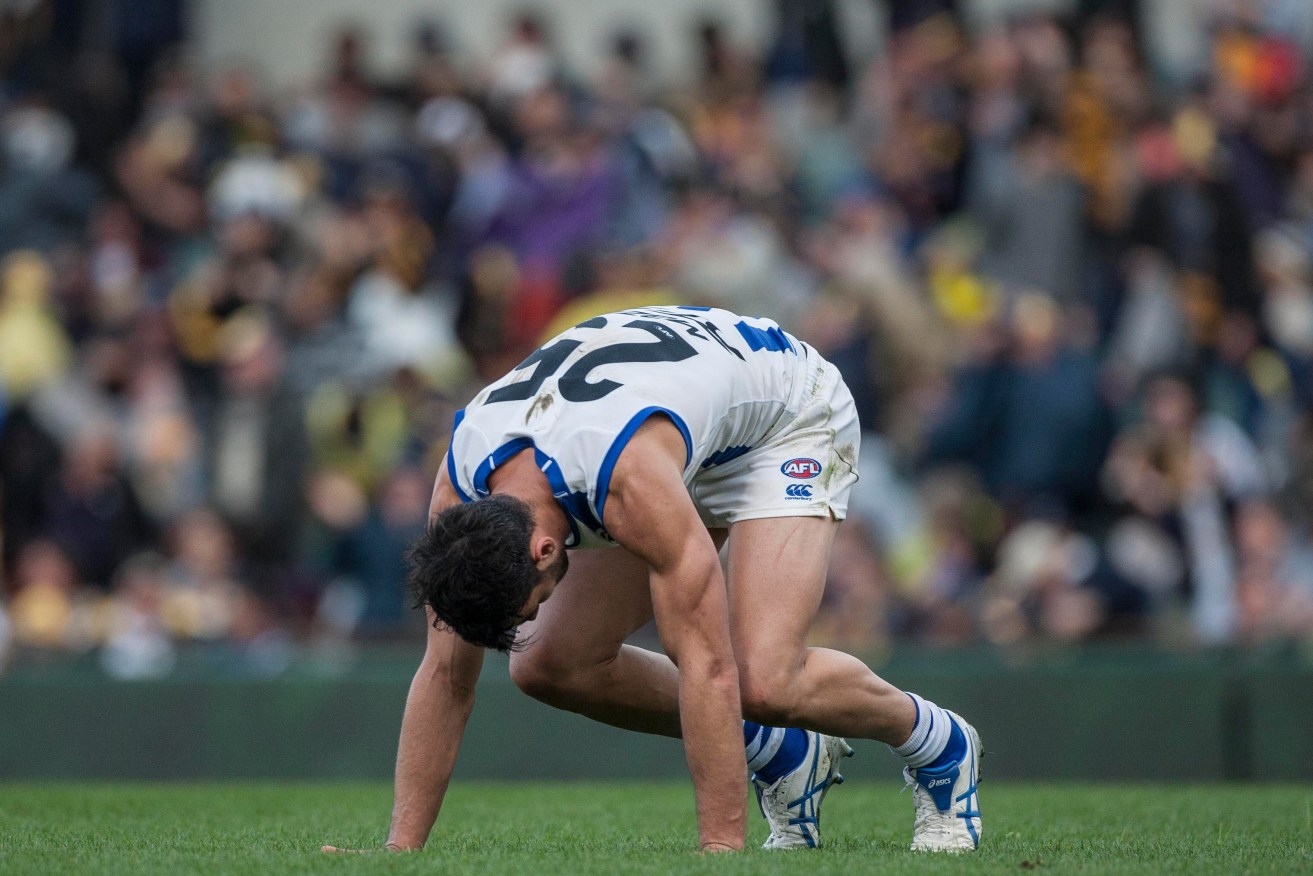 How the mighty have fallen: Robbie Tarrant after the final siren yesterday. After winning their first nine games, North Melbourne are suddenly on their knees. Photo: Tony McDonough, AAP.
