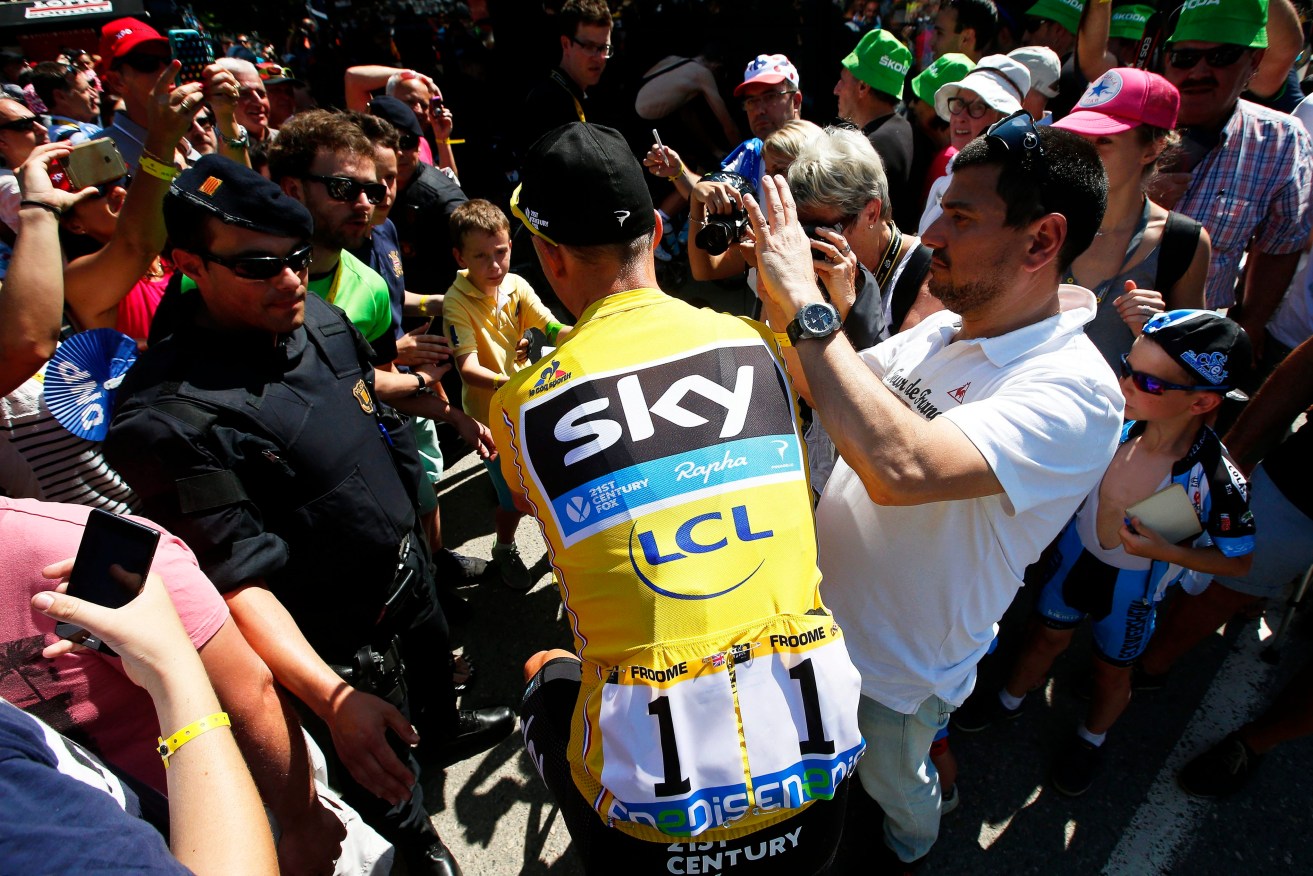 British rider Chris Froome of Team Sky makes his way through the crowd to sign in for the 9th stage of the Tour. Photo: KIM LUDBROOK, EPA.