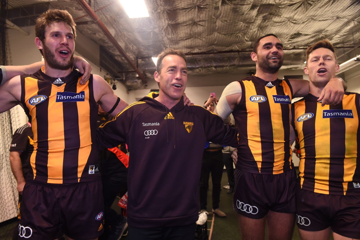 Hawks' coach Alastair Clarkson (centre) joins players in singing the team song following their win during the round 17 AFL match between the Sydney Swans and the Hawthorn Hawks at the Sydney Cricket Ground in Sydney on Thursday, July 14, 2016. (AAP Image/Paul Miller) NO ARCHIVING, EDITORIAL USE ONLY