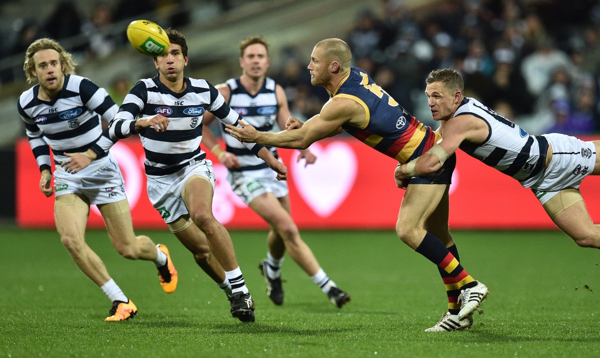 Joel Selwood of the Cats (right) and Scott Thompson of the Crows contest during the Round 18 AFL match between the Geelong Cats and the Adelaide Crows at Simonds Stadium in Geelong, Saturday, July 23, 2016. (AAP Image/Julian Smith) NO ARCHIVING, EDITORIAL USE ONLY