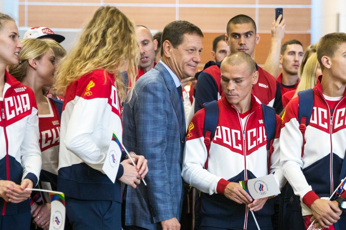 Russian Olympic Committee President Alexander Zhukov with Olympic team members set to depart for Rio. More than 100 Russians from the 387-strong Olympic team have been banned from the games. Photo: Pavel Golovkin, AP.