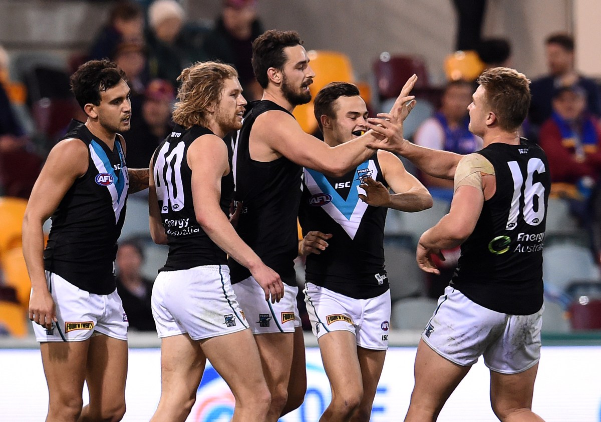 Port Adelaide Power players celebrates a goal during their round 19 AFL game against the Brisbane Lions at the Gabba in Brisbane, Saturday, July 30, 2016. (AAP Image/Dan Peled) NO ARCHIVING, EDITORIAL USE ONLY