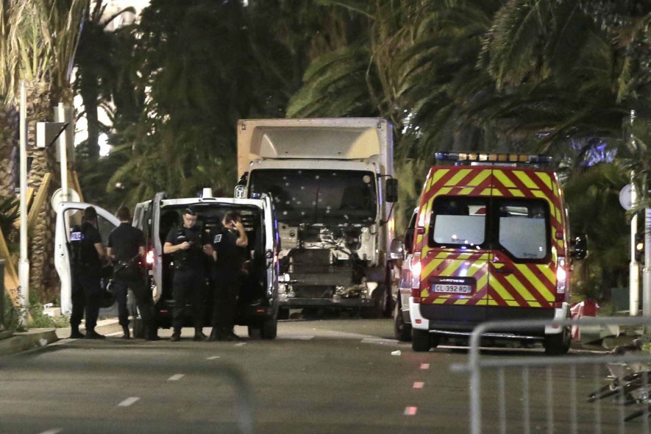 Police officers stand guard near the truck after it crashed into the crowd during the Bastille Day celebrations in Nice. Photo: EPA