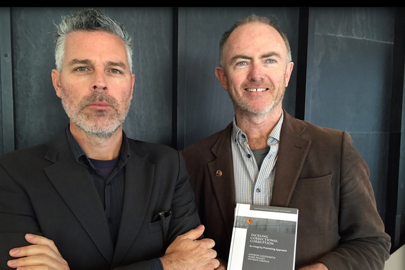 Professor Mark Halsey and Professor Andrew Goldsmith with the new book, Tackling Correctional Corruption (Palgrave Macmillan).