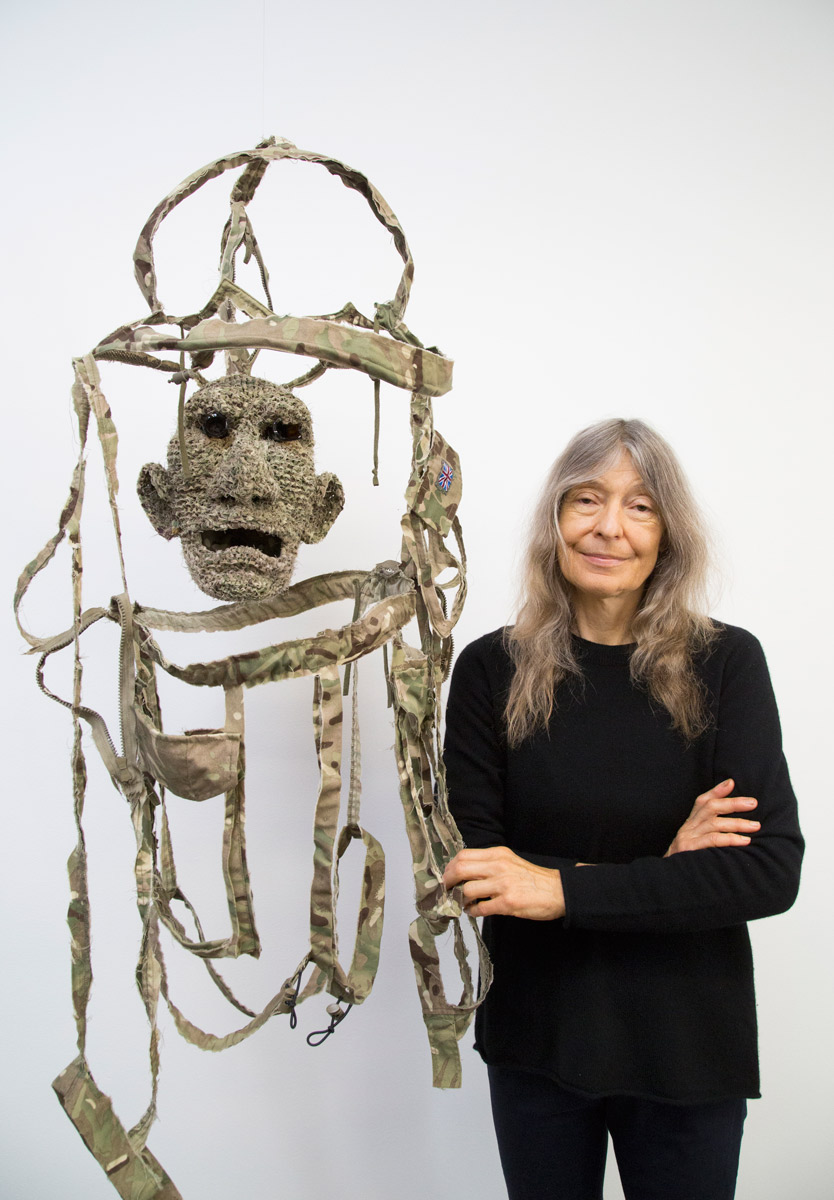 Fiona Hall pictured with a detail of 'All the King's Men'. Photo: Saul Steed