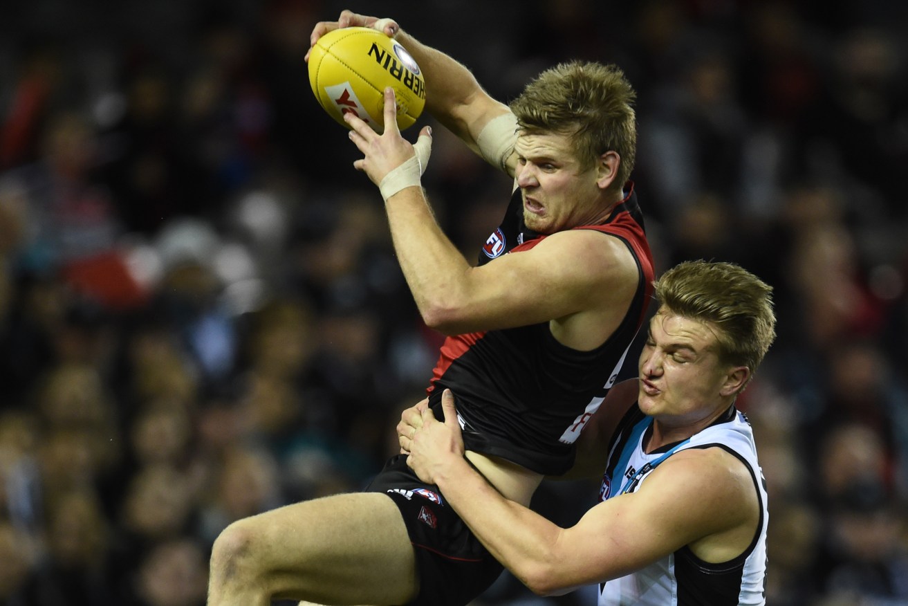 Michael Hurley under pressure from Port Adelaide's Ollie Wines last year. Photo: Julian Smith, AAP.
