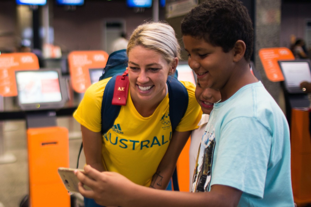 Matildas player Alanna Kenney poses for a photograph with a local at the airport in Fortaleza, Brazil ahead of the Olympics. Photo: AAP/Supplied.