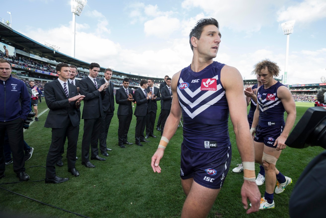 Matthew Pavlich leads the Dockers from the field in his 350th game - a 90-point thrashing by Sydney. Photo: Tony McDonough, AAP.