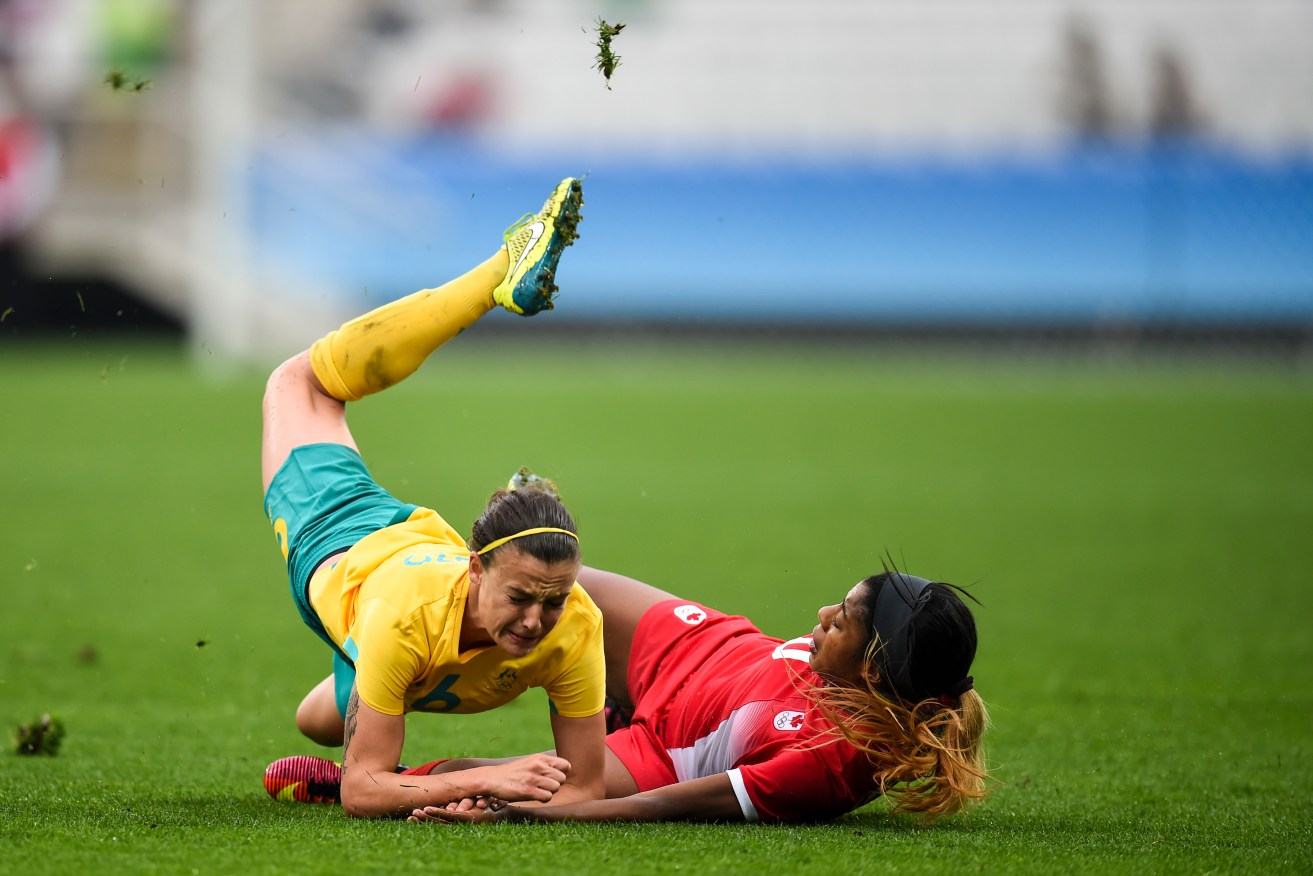 Canada's Desiree Scott fights for the ball with Australia's Chloe Logarzo. Photo: Lukas Coch, AAP.