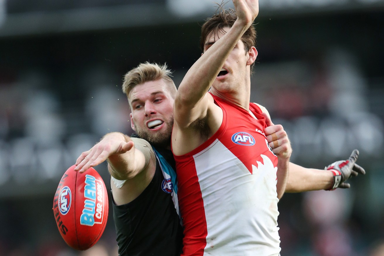 Jackson Trengove takes on Sam Naismith during Port's loss to the Swans. Photo: David Moir, AAP.