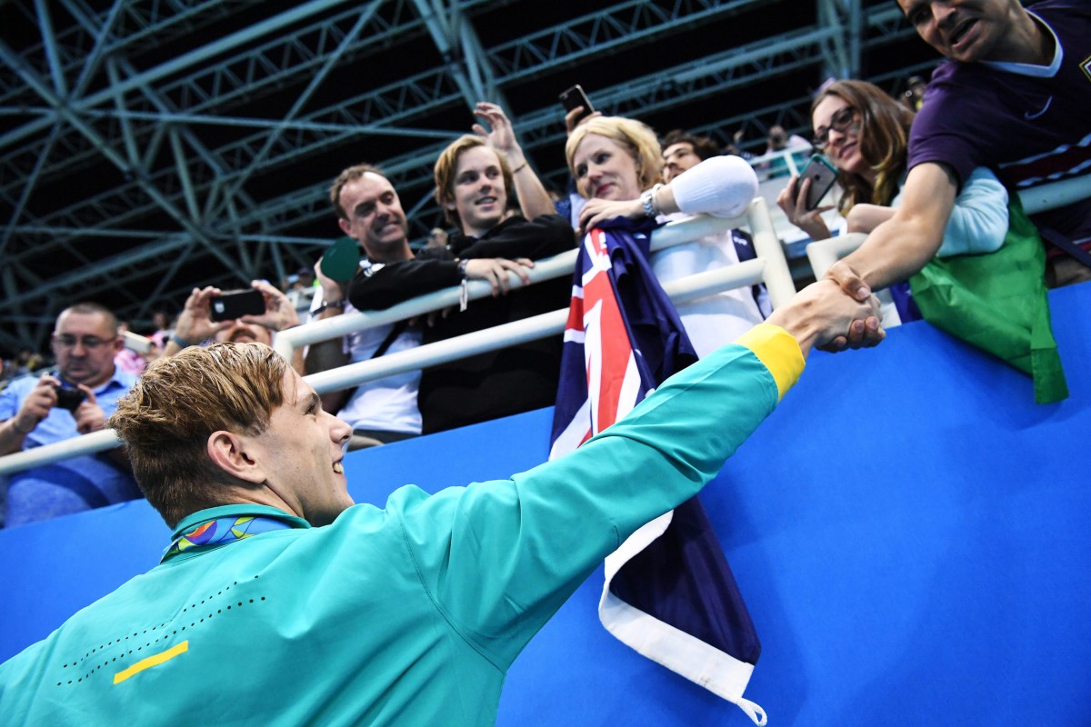 epa05472968 Gold medalist Kyle Chalmers of Australia is congratulated by fans after winning men's 100m reestyle Final race of the Rio 2016 Olympic Games Swimming events at Olympic Aquatics Stadium at the Olympic Park in Rio de Janeiro, Brazil, 10 August 2016. EPA/BERND THISSEN