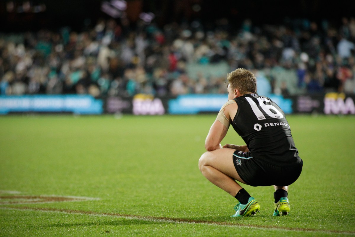 Ollie Wines of the Power reacts at the full time siren after their team lost to the Demons during the Round 21 AFL match between the Port Adelaide Power and the Melbourne Demons at Adelaide Oval in Adelaide, Saturday, Aug. 13, 2016. (AAP Image/Ben Macmahon) NO ARCHIVING, EDITORIAL USE ONLY