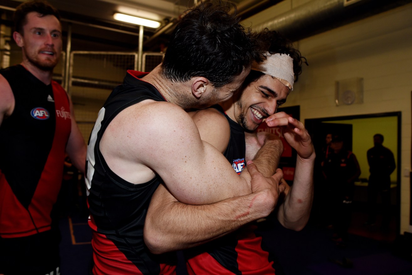 Debutant Jake Long - son of Essendon champion Michael - celebrates only the Bombers' second win of the season. Photo: Tracey Nearmy, AAP.