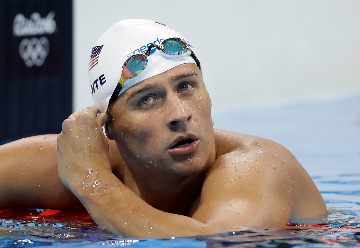 FILE - In this Tuesday, Aug. 9, 2016, file photo, United States' Ryan Lochte checks his time in a men's 4x200-meter freestyle heat during the swimming competitions at the 2016 Summer Olympics, in Rio de Janeiro, Brazil. Lochte and three other American swimmers were robbed at gunpoint early Sunday, Aug. 14, by thieves posing as police officers who stopped their taxi and took their money and belongings, the U.S. Olympic Committee said. (AP Photo/Michael Sohn, File)