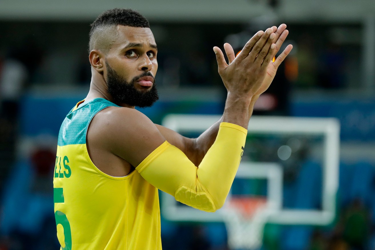 Australia's Patty Mills reacts to fans after the win over Lithuania. Photo: Charlie Neibergall, AP.