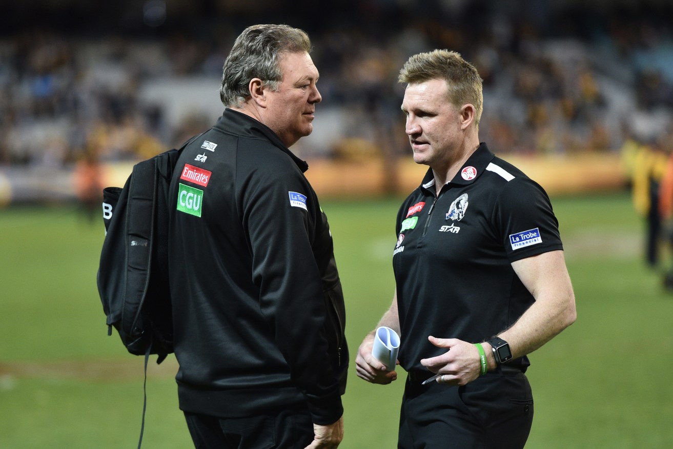Collingwood Head of Football Neil Balme speaks with coach Nathan Buckley after yesterday's loss to Hawthorn. Photo: Julian Smith / AAP