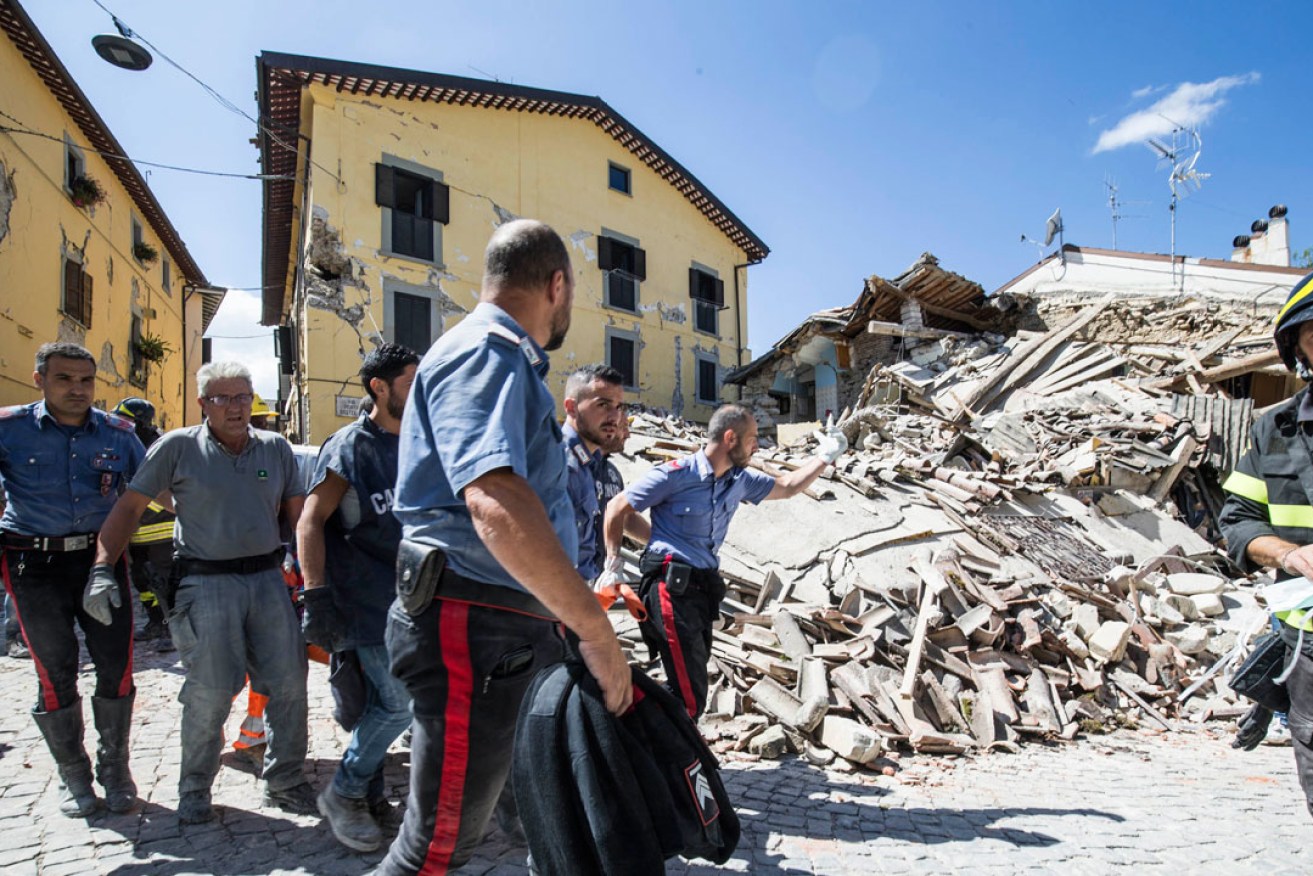 Rescuers search for survivors in the town of Amatrice. Photo: PA