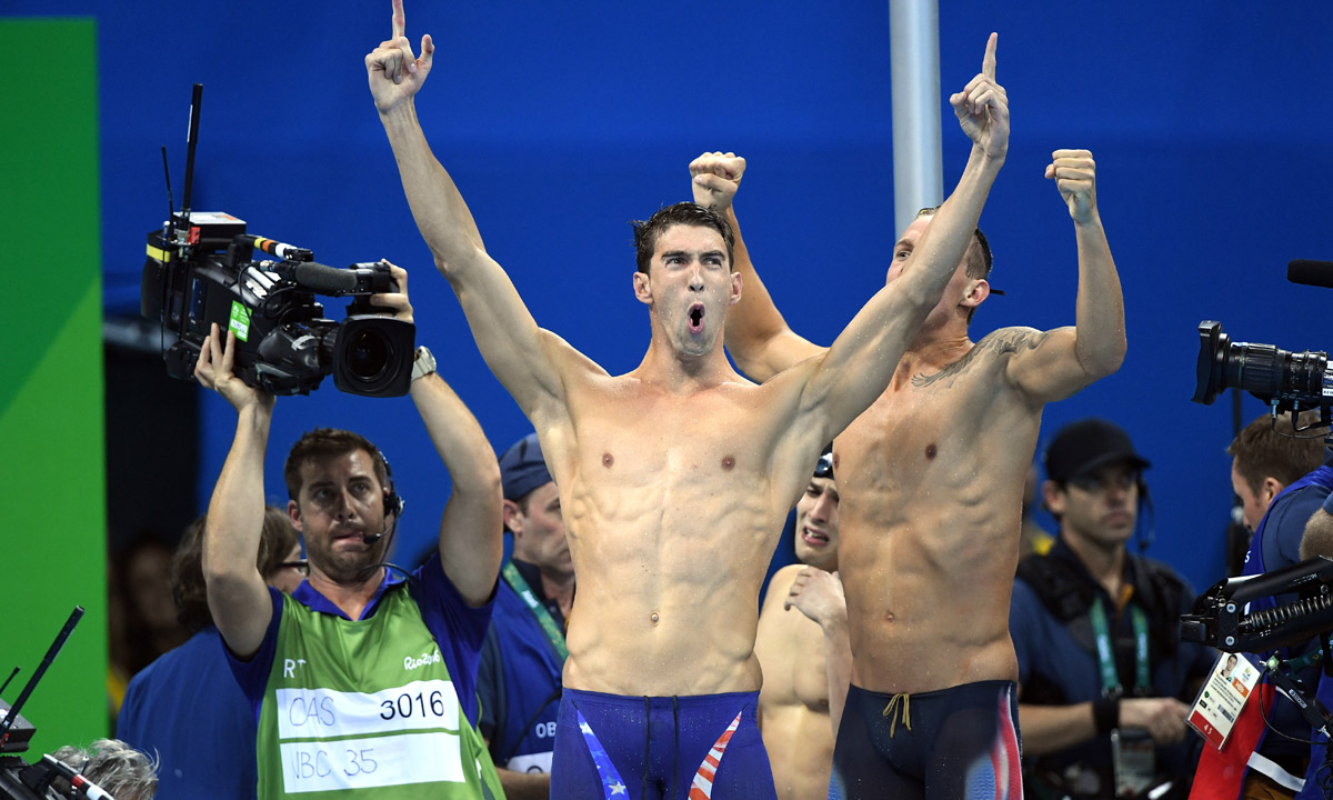 Michael Phelps celebrates the US win in the 4x100 relay. Photo: AAP