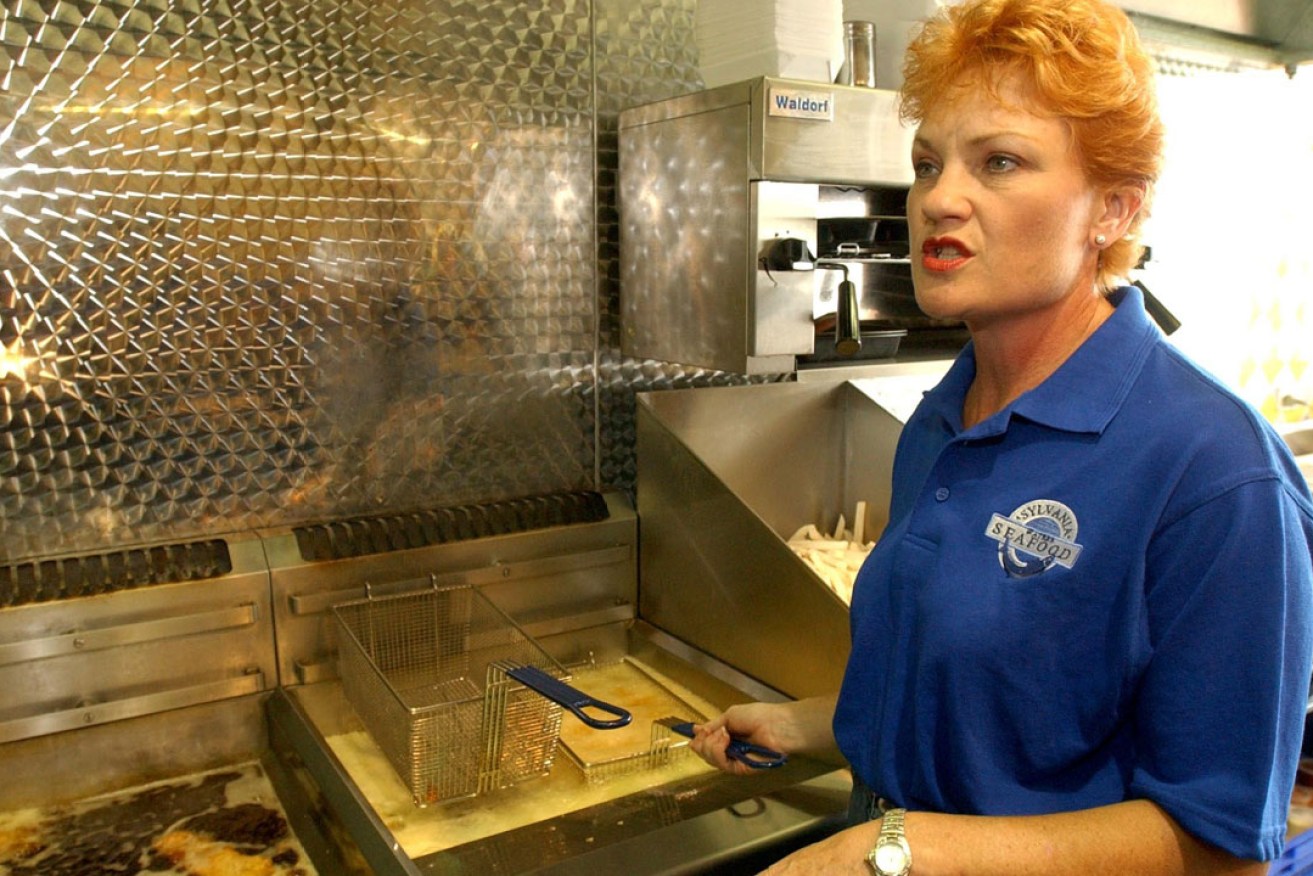 Out of the frying pan ... Pauline Hanson helping out at Sylvania Waters fish and chip shop in 2003. Photo: AAP