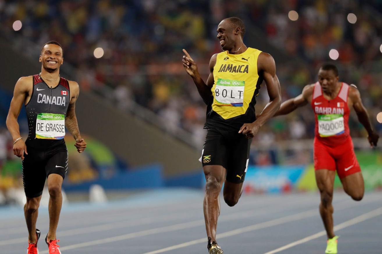 Usain Bolt passes  Canada's Andre De Grasse in the men's 200m semi-final. Photo: AP
