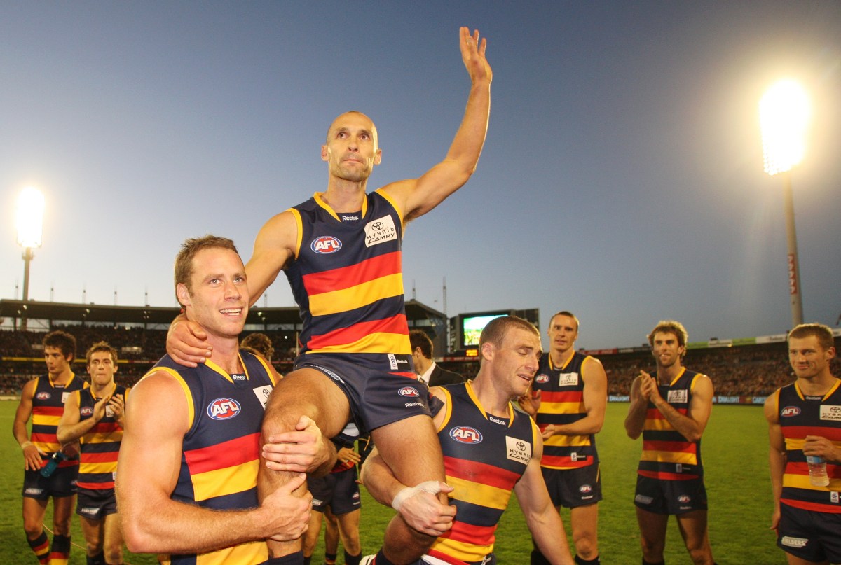 Adelaide Crows' Tyson Edwards is carried off the field after his last game of AFL by team mates Ben Rutten (left) and Simon Goodwin (right) after the round 11 AFL match between the Adelaide Crows and Fremantle, at AAMI stadium, Adelaide, Saturday, June 5, 2010. Adelaide defeated Fremantle 16.9 (105) to 12.10 (82). (AAP Image/Ben Macmahon) NO ARCHIVING, EDITORIAL USE ONLY