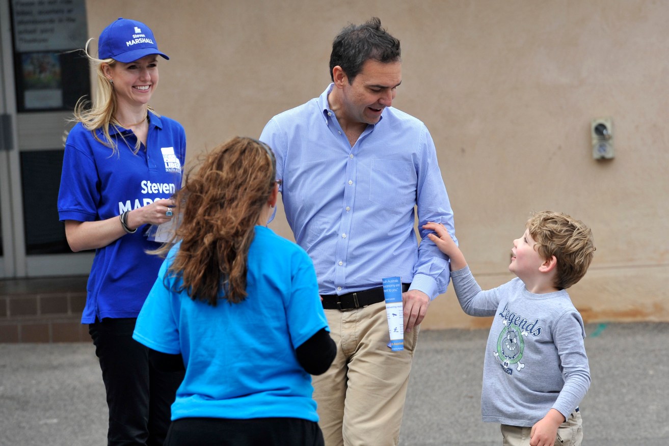 Liberal leader Steven Marshall meets a young supporter at a polling booth on election day, 2014. Photo: David Mariuz / AAP