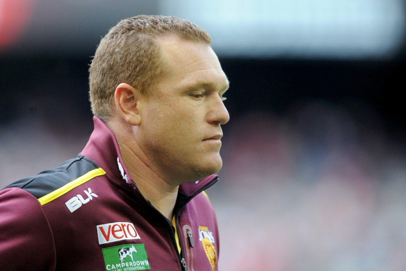 A disappointed Justin Leppitsch walks off the ground in his final game as Brisbane coach. Photo: Joe Castro / AAP