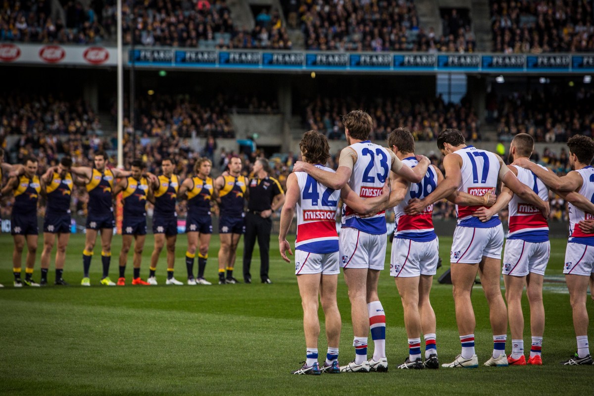 The West Coast Eagles and the Western Bulldogs line up for the National Anthem during the AFL Elimination Final between the West Coast Eagles and the Western Bulldogs at Domain Stadium Stadium in Perth, Thursday, Sept. 8, 2016. The Bulldogs won the match 99-52.(AAP Image/Tony McDonough) NO ARCHIVING, EDITORIAL USE ONLY
