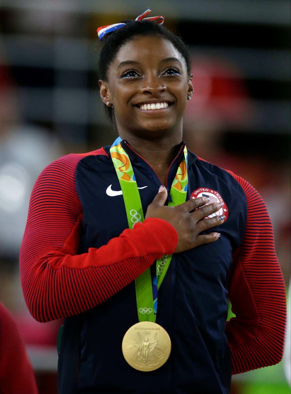 FILE - In this Aug. 16, 2016, file photo, United States' Simone Biles stands during the national anthem after winning the gold medal in the women's floor exercise at the 2016 Summer Olympics in Rio de Janeiro, Brazil. Confidential medical data of gold medal-winning gymnast Simone Biles, seven-time Grand Slam champion Venus Williams and other female U.S. Olympians was hacked from a World Anti-Doping Agency database and posted online Tuesday, Sept. 13, 2016. WADA said the hackers were a "Russian cyber espionage group" called Fancy Bears. (AP Photo/Rebecca Blackwell, File)