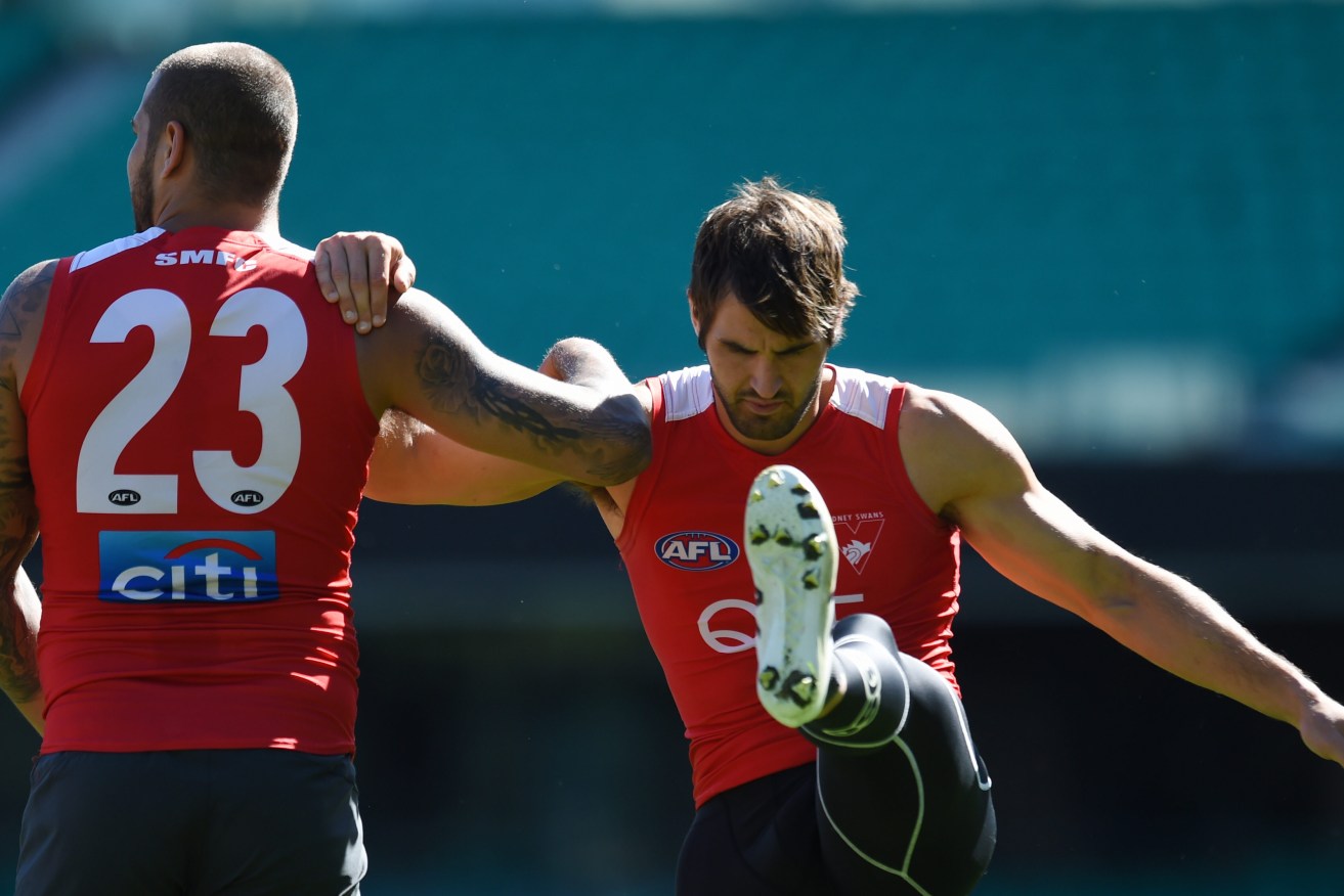 Josh Kennedy at Swans training yesterday, flanked by Lance Franklin. Photo: Dean Lewins / AAP