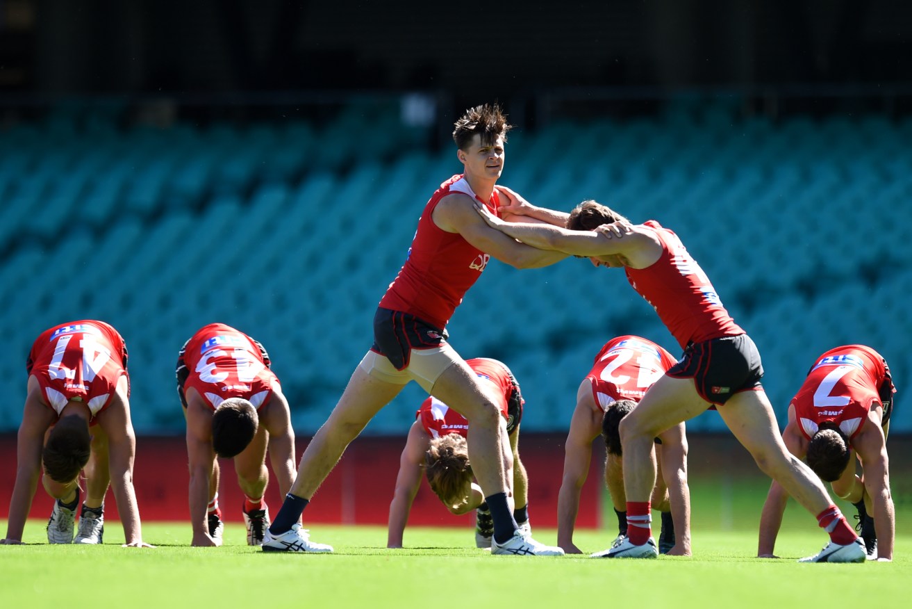 Sydney Swans player Callum Sinclair flexes his muscles during training today. Photo: Dean Lewins / AAP