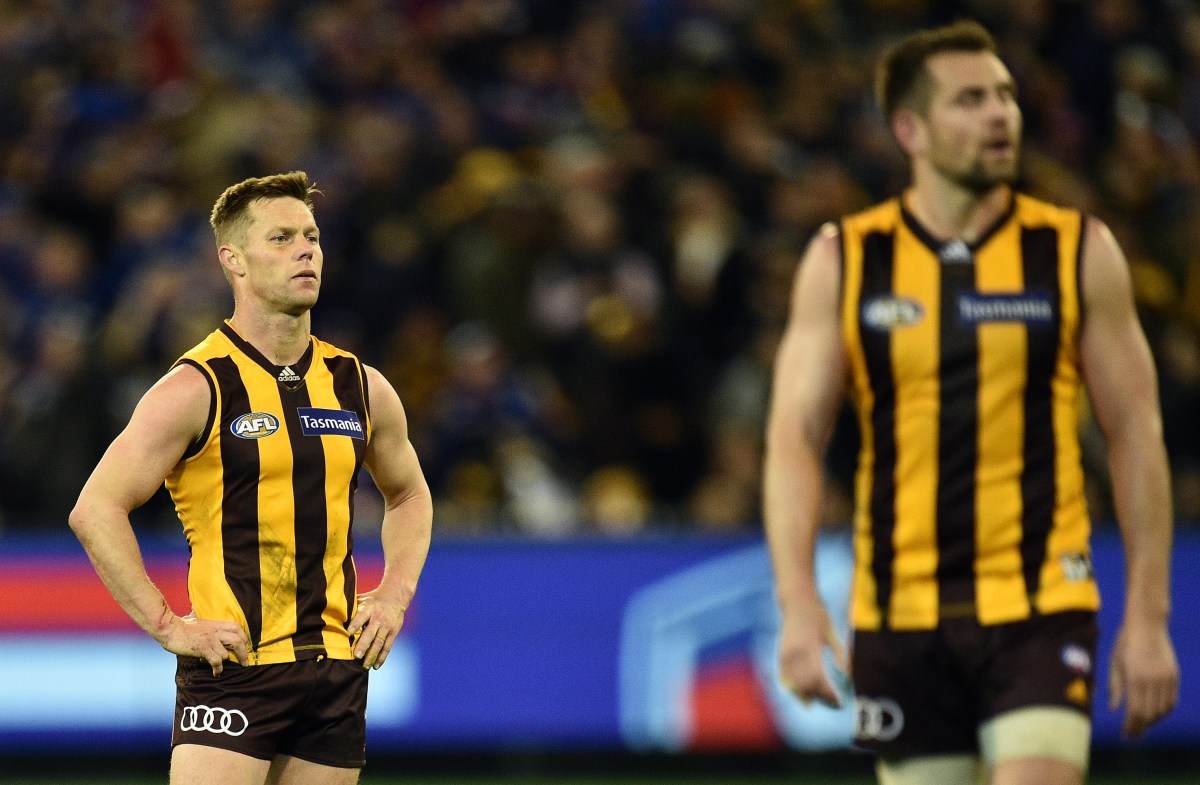 Sam Mitchell (left) and Luke Hodge of the Hawks react after the AFL Semi-Final match between the Hawthorn Hawks and the Western Bulldogs at the MCG in Melbourne, Friday, Sept. 16, 2016. (AAP Image/Julian Smith) NO ARCHIVING, EDITORIAL USE ONLY