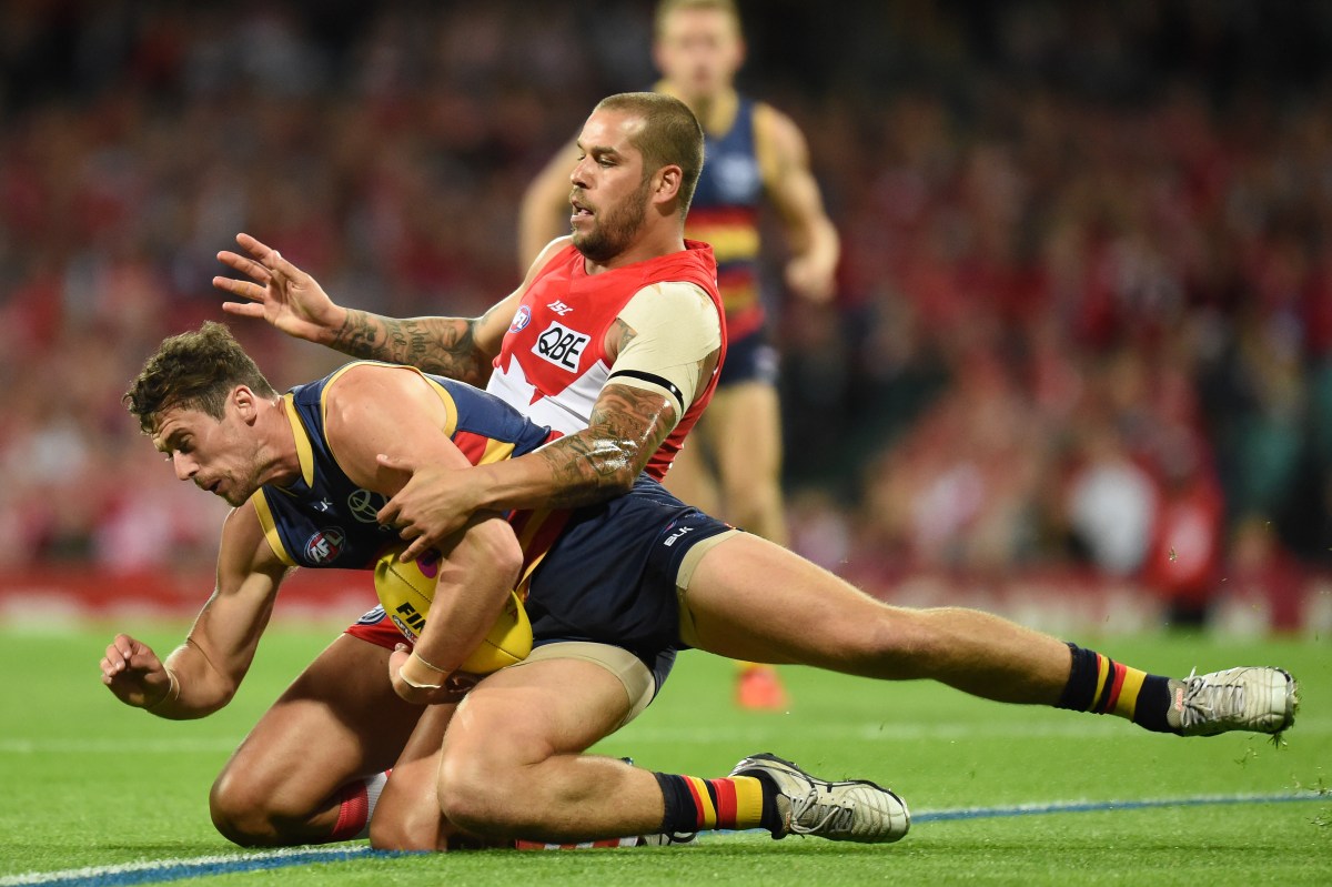 Lance Franklin of the Swans tackles Kyle Hartigan of the Crows during the 1st semi-final AFL match between the Sydney Swans and the Adelaide Crows at the Sydney Cricket Ground in Sydney, Saturday, Sept. 17, 2016. (AAP Image/Dean Lewins) NO ARCHIVING, EDITORIAL USE ONLY