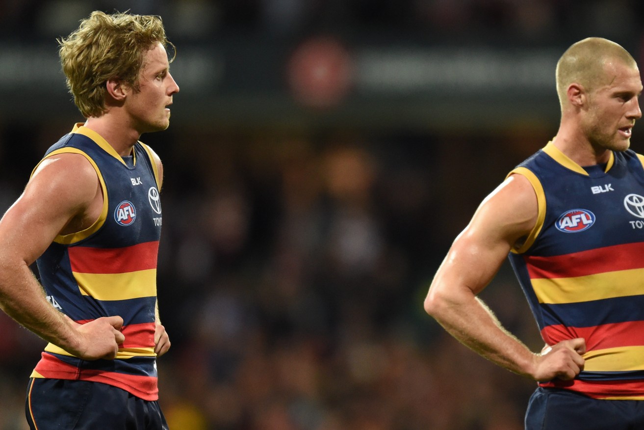 Scott Thompson contemplates his football future with Rory Sloane after the loss to the Swans. Photo: Dean Lewins / AAP