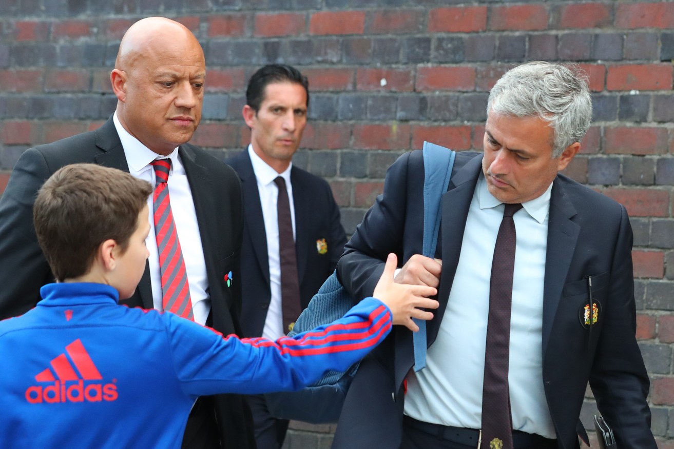 Jose Mourinho looks shocked that a young fan still wants to shake his hand as Manchester United catch the train home from London after their 3-1 defeat to Watford. 