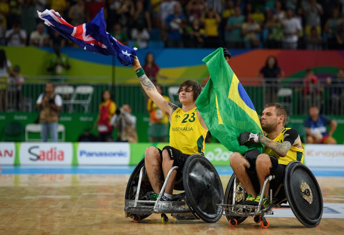 In this photo provided by the IOC, Australia's Jayden Warn, left, and Ryan Scott celebrates defeating the USA in the gold medal mixed wheelchair rugby match at the Rio Paralympics in Rio de Janeiro, Brazil , Sunday Sept. 18, 2016. (Bob Martin/OIS, IOC via AP)