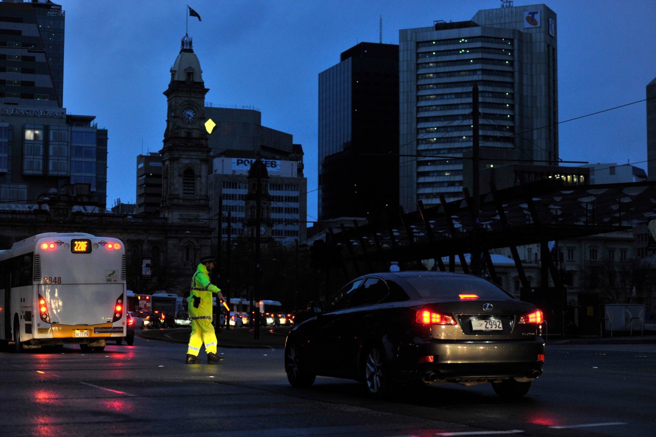 Police direct traffic around the CBD during the 2016 statewide blackout. Photo: AAP