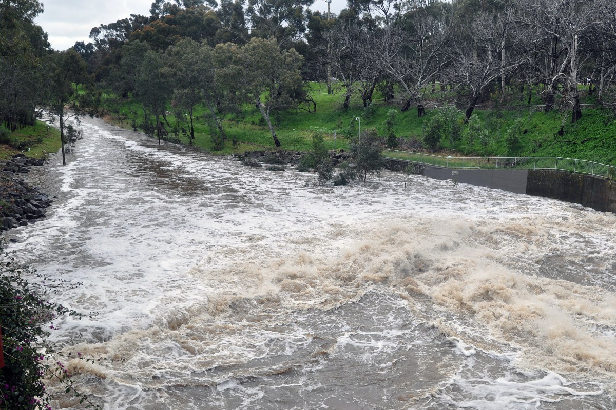 Floodwater surge down the River Torrens in Adelaide, Thursday, Sept. 29, 2016. The Bureau of Meteorology has warned of more wild weather to hit the state, which could produce wind gusts of up to 140km/h, especially along the west coast of Eyre Peninsula and up to 100mm of rain across the Adelaide Hills, bringing the risk of flooding. The warnings come a day after wild winds ripped at least 22 transmission towers from the ground across the mid-north with about 80,000 lightning strikes hitting the state, some damaging generation facilities. (AAP Image/Tim Dornin) NO ARCHIVING