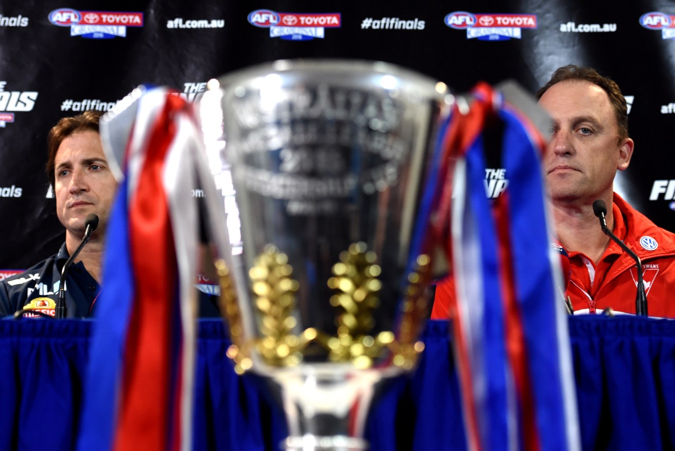 Bulldogs coach Luke Beveridge and Swans mentor John Longmire, eyeing the premiership cup ahead of today's Grand Final parade. Photo: Tracey Nearmy / AAP