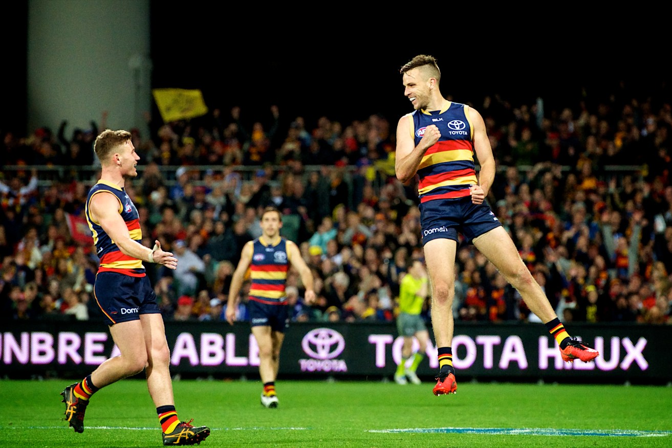 WALKING ON AIR: Brodie Smith shares a moment with Rory Laird after kicking the final goal of the game from 50 metres. Photo: Michael Errey / InDaily