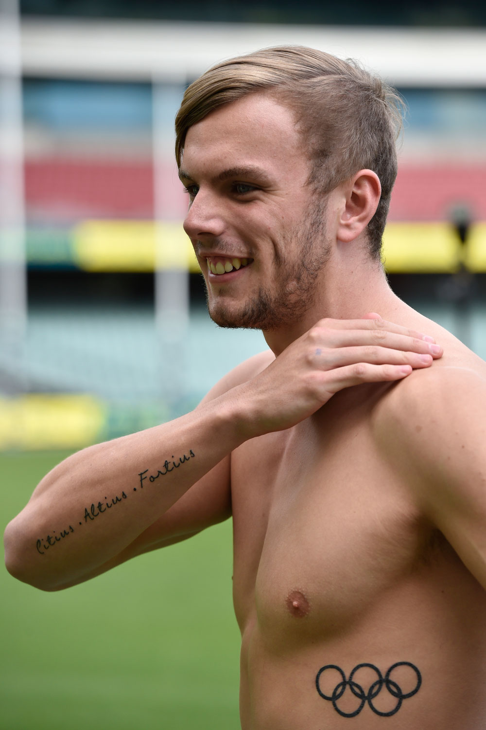 Kyle Chalmers shows off his new Olympic tattoos. Photo: David Mariuz/AAP