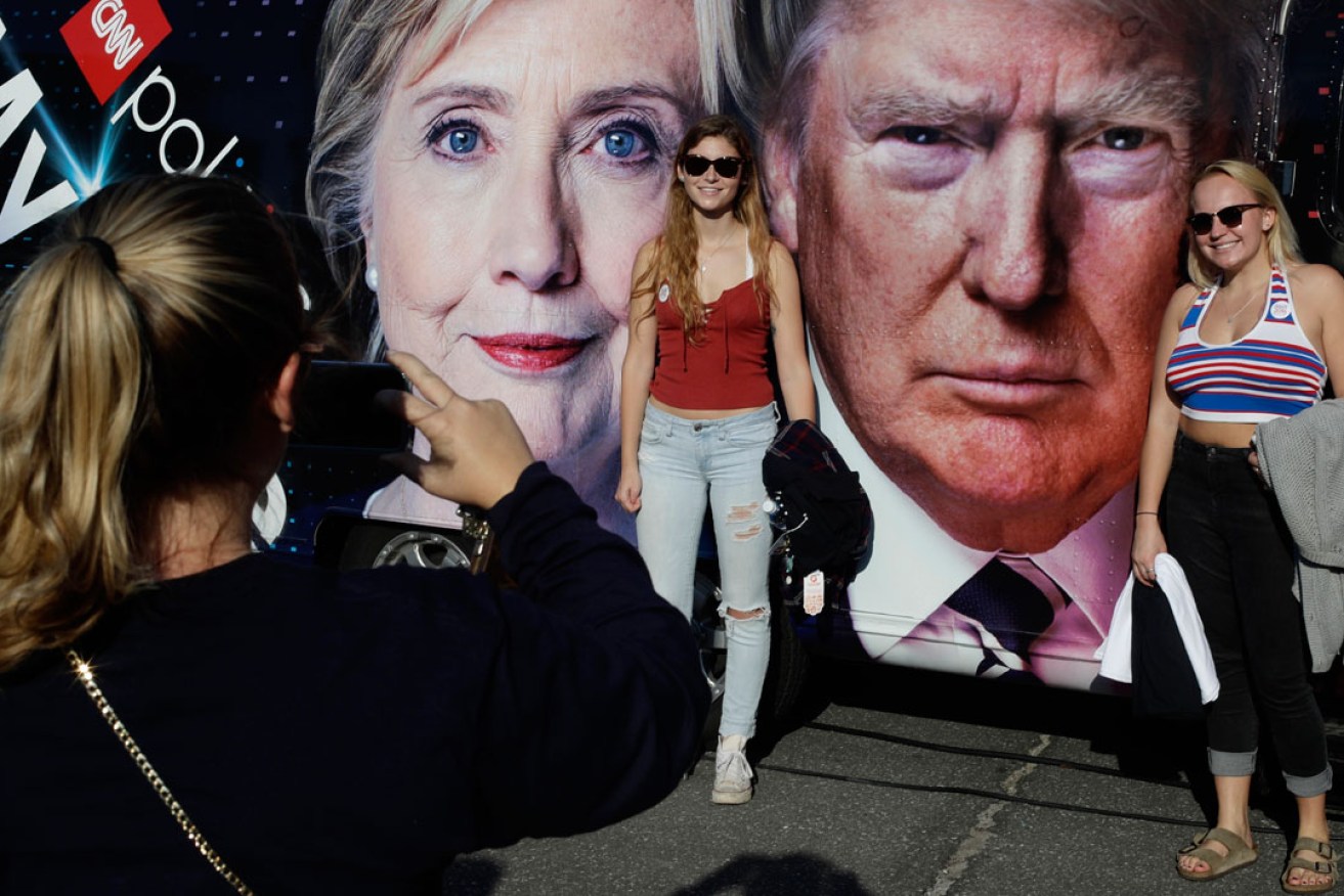Students pose for photographs near the presidential debate between Hillary Clinton and Donald Trump at Hofstra University. Photo:  AP
