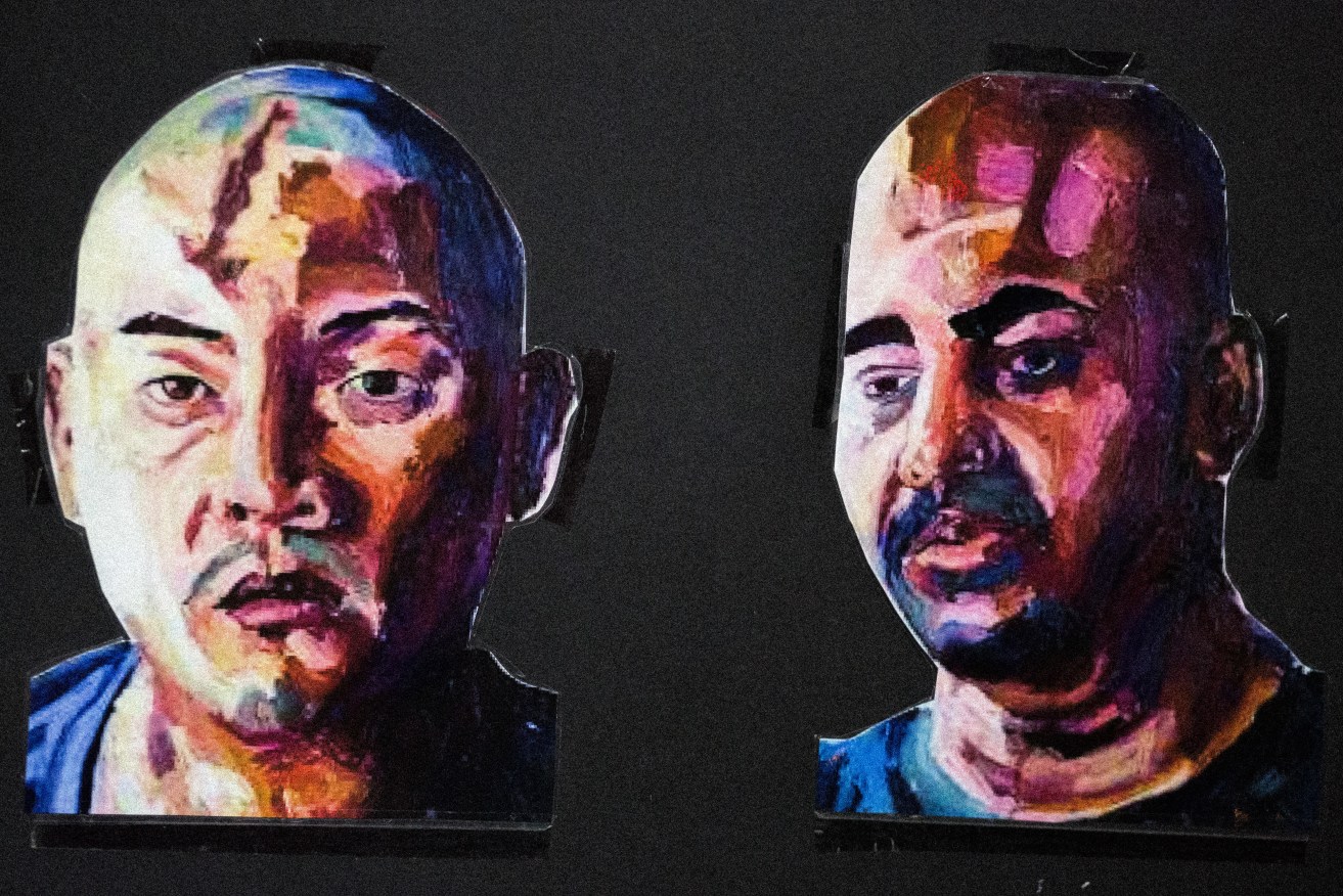 Two paintings by Myuran Sukumaran - on the left, Andrew Chan, on the right, a self-portrait - are displayed during a candlelight vigil in Sydney's Martin Place on the eve of the men's executions. Some of Sukumaran's paintings have been stolen in an Adelaide burglary. Photo: RICHARD ASHEN / NewZulu via AAP 