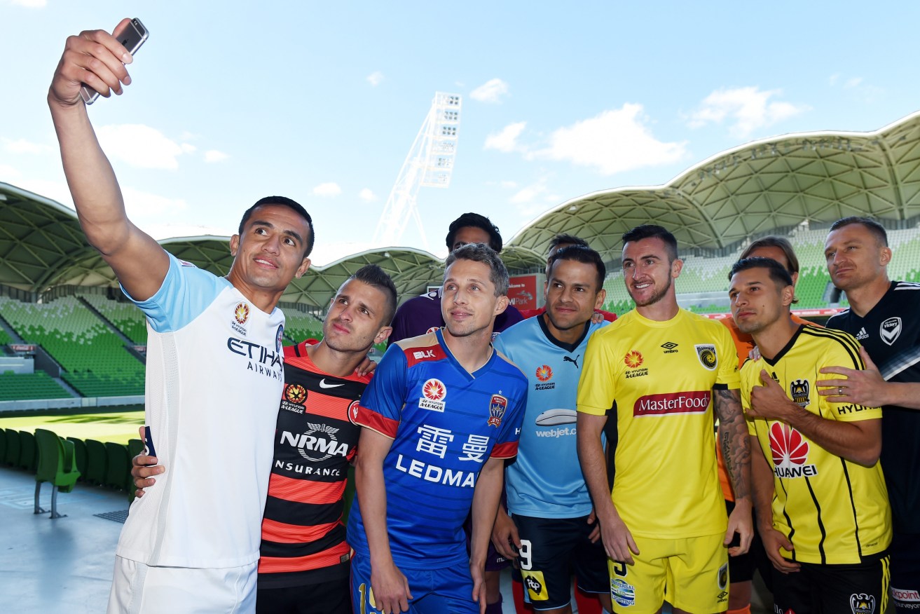 Tim Cahill takes a selfie with players from other A-League sides at a pre-season promotion. Photo: Tracey Nearmy / AAP