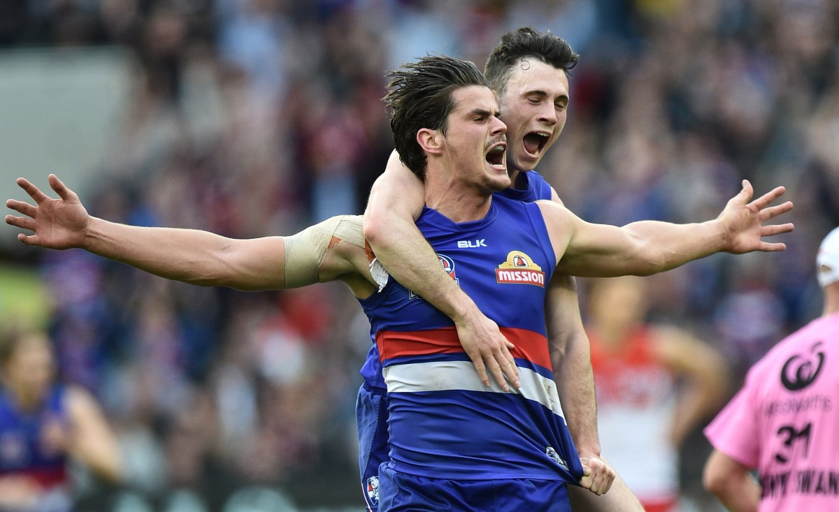 Tom Boyd (left) and Toby McLean of the Western Bulldogs (left) react after Boyd kickded a goal during the AFL Grand Final between the Sydney Swans and the Western Bulldogs at the MCG in Melbourne, Saturday, Oct. 1, 2016. (AAP Image/Julian Smith) NO ARCHIVING, EDITORIAL USE ONLY