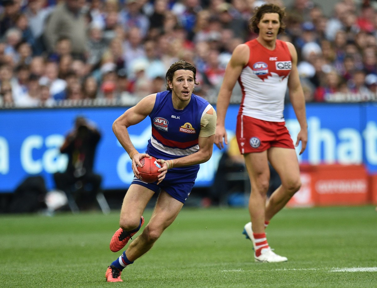 Marcus Bontempelli (left) of the Bulldogs is seen in action during the AFL Grand Final between the Sydney Swans and the Western Bulldogs at the MCG in Melbourne, Saturday, Oct. 1, 2016. (AAP Image/Julian Smith) NO ARCHIVING, EDITORIAL USE ONLY