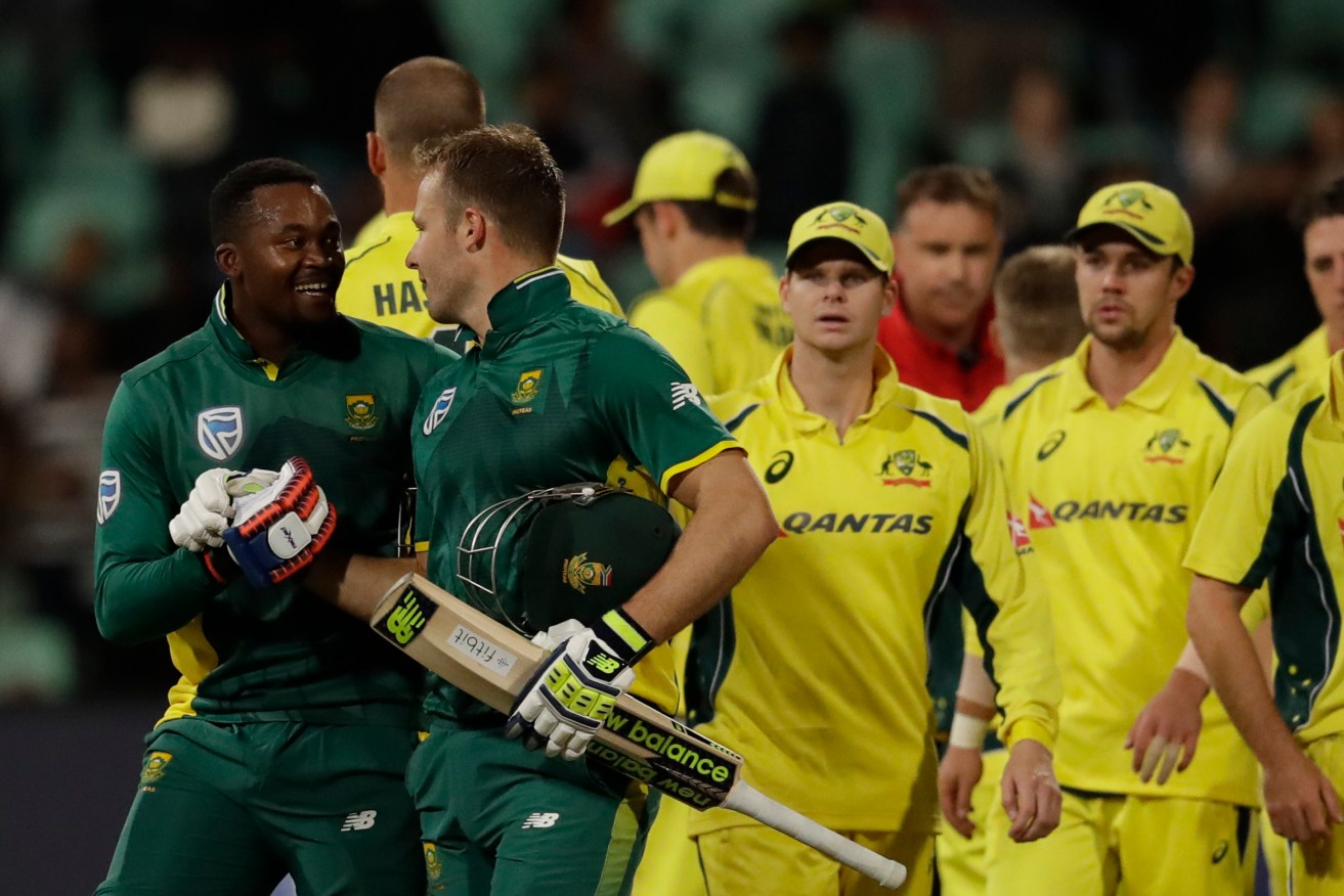 Australian skipper Steve Smith is stunned as South African batsmen Andile Phehlukwayo and David Miller leave the field victorious. Photo: Themba Hadebe / AP
