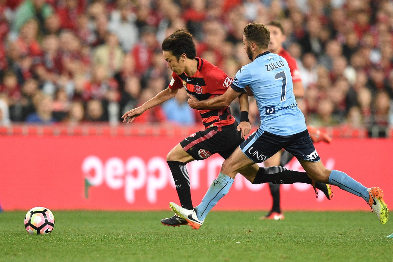 Jumpei Kusukami of the Wanderers competes for possession with Michael Zullo of Sydney. Photo: AAP/Dan Himbrechts